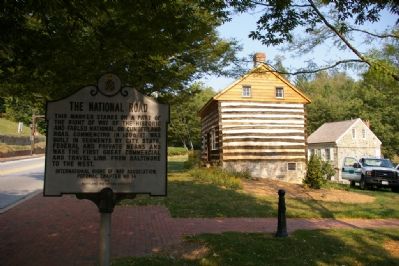 Marker with historic cabin and building image. Click for full size.