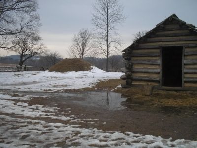 Log Cabin with a bee hive oven in background. Click for full size. Log Cabin with a bee hive oven in background image. Click for full size.