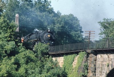 Steam Locomotive Passes Marker, Charges Across Viaduct. Click for full size. Steam Locomotive Passes Marker, Charges Across Viaduct image. Click for full size.