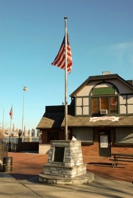 The plaque is at the base of the flagpole near the baseball diamond. image. Click for full size.