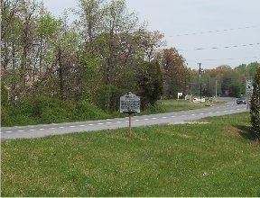 The marker as viewed from Blossom Point Road. Port Tobacco Road (State Route 6) is in background. image. Click for full size.