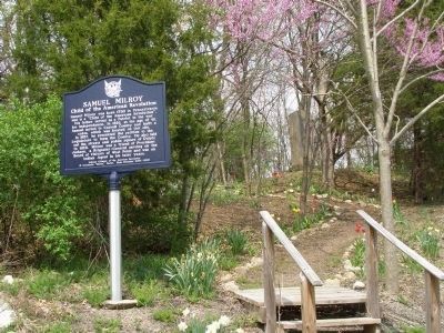 The Monument is on the hilltop behind this metal marker. image. Click for full size.
