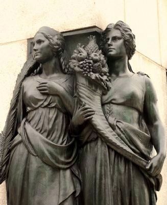 Two of the four allegorical female figures, "Peace" and "Plenty." image. Click for full size.