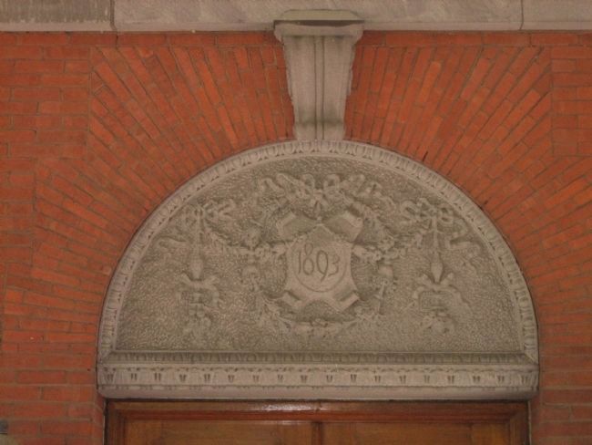 The intricately carved datestone on the Administration Building. image. Click for full size.