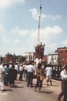 "The Spirit of Freedom" is lowered into place at the still unfinished memorial image. Click for full size.