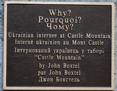 Marker on statue of internee image. Click for full size.