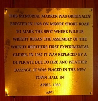 This brass plaque identifies why the memorial was moved inside the town hall image. Click for full size.
