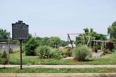 Marker and gardens next to apartments. image. Click for full size.