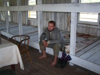Interior of prison barracks image. Click for full size.