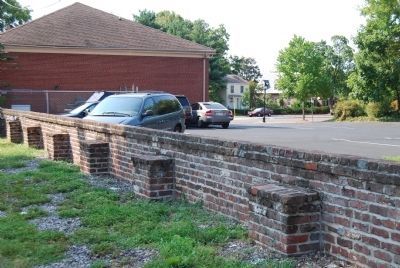 The remainng brick wall on the western side of the park. image. Click for full size.
