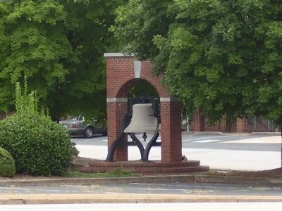 Bell across the road from the District Five War Memorial Marker image. Click for full size.