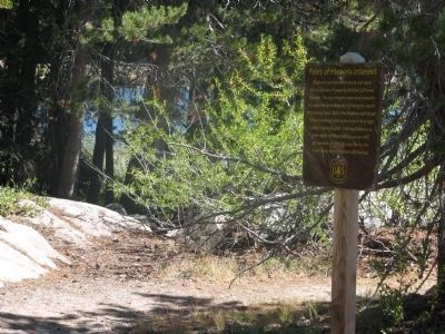 Bedrock Mortars Marker with Lake Alpine in Background. Click for full size. Bedrock Mortars Marker with Lake Alpine in Background image. Click for full size.