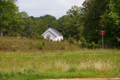 Sacred Harp Singing Marker and Holly Springs Church across US 27. Click for full size. Sacred Harp Singing Marker and Holly Springs Church across US 27 image. Click for full size.