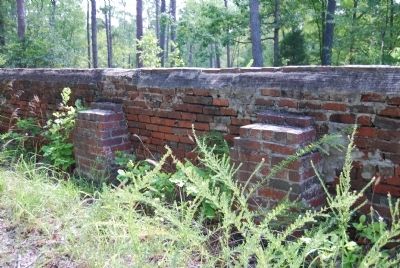 Newer brick columns hold up the sagging wall image. Click for full size.