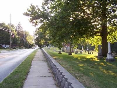 Looking down the street at the marker and cemetery image. Click for full size.
