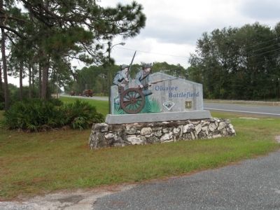 The Battle of Olustee State Park sign - note lumber trucks in background image. Click for full size.