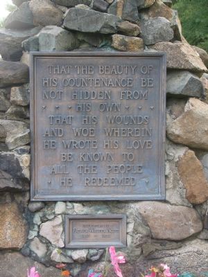 Plaque located on the South base of the Crucifix image. Click for full size.