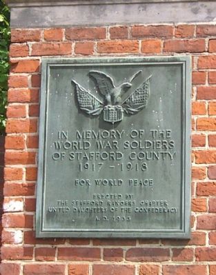 Plaque on Brickwork at Church Exit - Northside image. Click for full size.