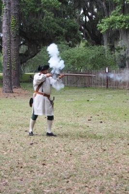 Frederica - The Fort Historian / Living History Musket Firing. Click for full size. Frederica - The Fort Historian / Living History Musket Firing image. Click for full size.