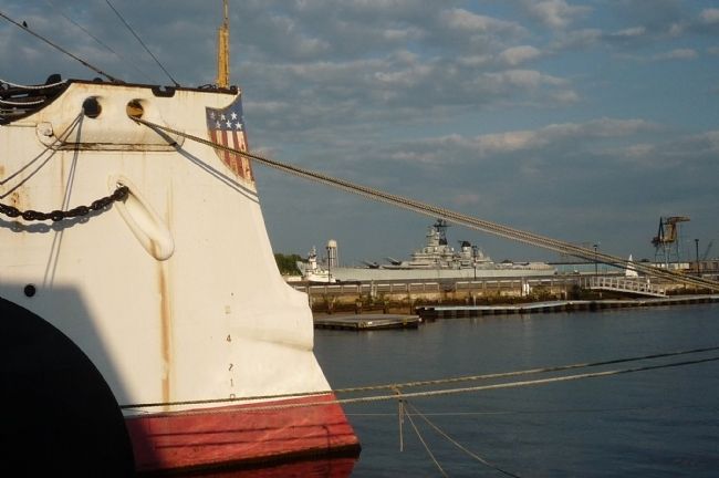 View of Cruiser <i>Olympia</i>'s ram-style bow - with the WWII battleship USS <i>New Jersey</i> image. Click for full size.