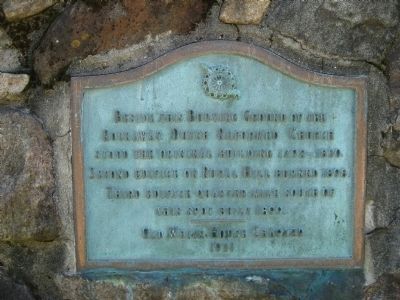 Marker on exterior wall of cemetery image. Click for full size.