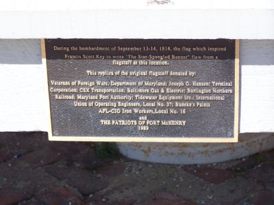 Plaque at base of flagstaff image. Click for full size.