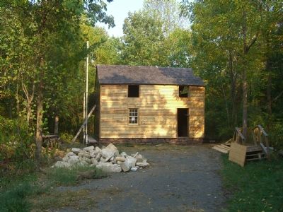 John W. Hall's log cabin, undergoing renovation. image. Click for full size.