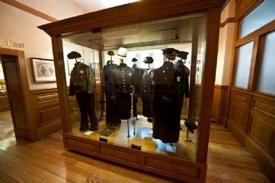 Display of historic NYC Police uniforms in the museum image. Click for full size.