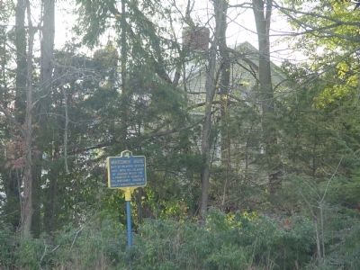 Montgomery House in background behind marker and obscured by vegetation. image. Click for full size.