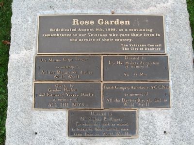 The plaques on the stone behind the flagpole image. Click for full size.