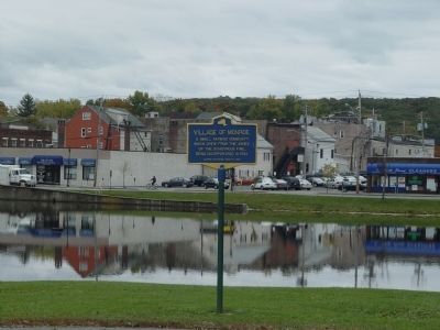 Downtown Monroe as seen looking past marker across the old Mill Pond. image. Click for full size.