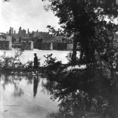 View of burned district and ruins of Mayo's bridge from across the James River. image. Click for full size.