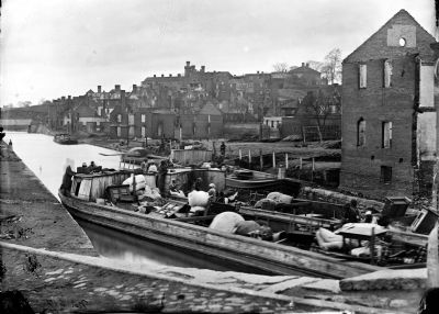 Richmond, Va. Barges with African Americans on the Canal; ruined buildings beyond. image. Click for full size.