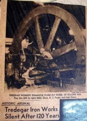 Workers dismantle the rolling mill flywheel image. Click for full size.