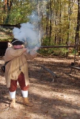 Reenactor firing the musket.. Click for full size. Reenactor firing the musket. image. Click for full size.