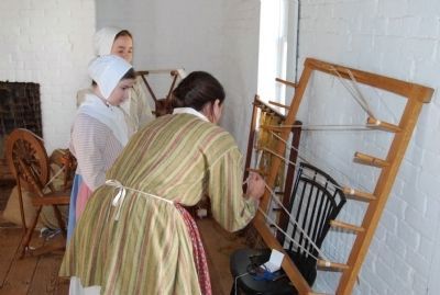 Reenactor working with yarn image. Click for full size.