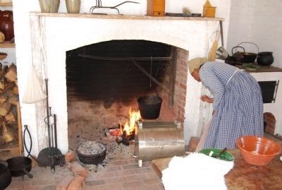 Reenactor cooking in the kitchen. Click for full size. Reenactor cooking in the kitchen image. Click for full size.