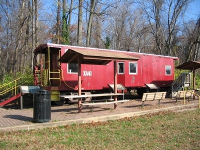 Three Markers in front of an Old Caboose image. Click for full size.