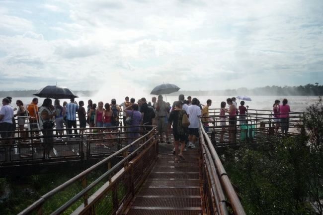 Tourists view the centerpiece <i>Garganta del Diablo</i> (Devil's Throat) falls image. Click for full size.