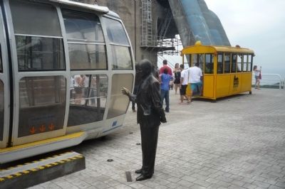 Augusto Ferreira Ramos statue with display of vintage cable cars on Urca Mountain image. Click for full size.