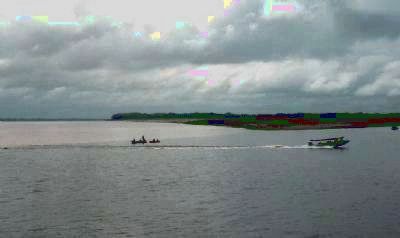 Fishing boats at the "Meeting of the Waters" - in the rainforest below the Port of Manaus image. Click for full size.