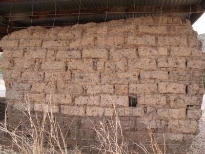 Closeup of wall showing adobe construction image. Click for full size.