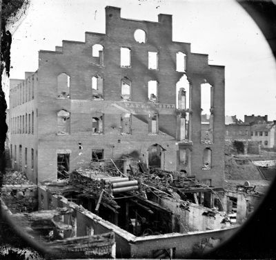 Ruins of paper mill; wrecked paper-making machinery in foreground image. Click for full size.