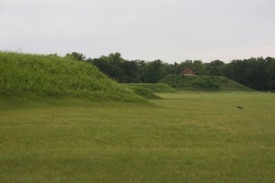 Mound B in the distance with replica of a hut. Mound B is the highest mound in the park image. Click for full size.