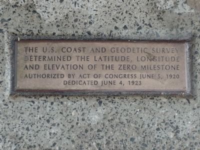 Close-up of plaque in the sidewalk below the north face of the monument image. Click for full size.