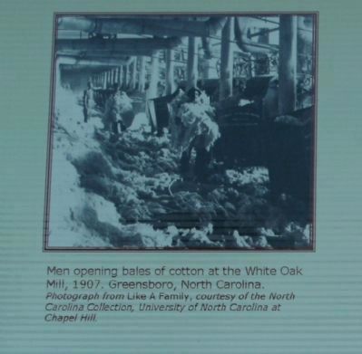 Men opening bales of cotton image. Click for full size.