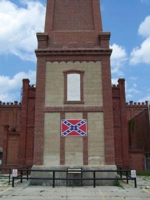 The Confederate States Powder Works Marker, seen behind railing, under flag image. Click for full size.