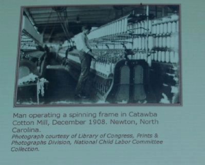 Man operating a spinning frame in Catawba Cotton Mill image. Click for full size.