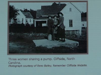 Three women sharing a pump, Cliffside, North Carolina. image. Click for full size.