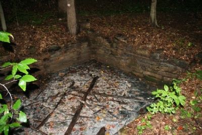 Stone wall surrounding one of the springs that emits white sulfur. image. Click for full size.